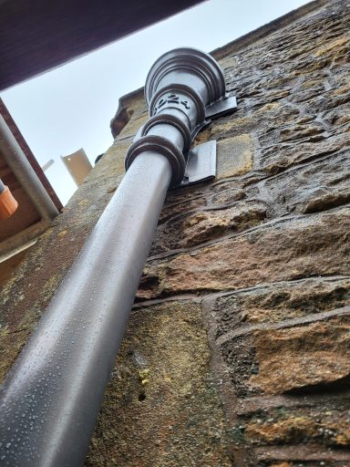 Bossed lead rainwater hopper head with date 2025 and leap pipe